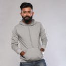 Home Portrait of a stylish bearded man wearing a gray hoodie, posing against a white background.