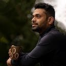 Home Thoughtful man with a cup, enjoying a peaceful moment outdoors.
